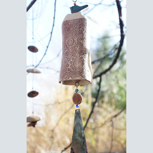 White ceramic wind chime with blue glazed bird topper and patinaed copper sail