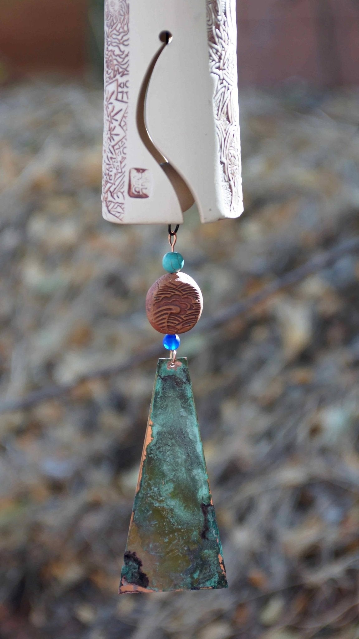 Garden wind chime with white ceramic bell and blue bird, handmade craftsmanship