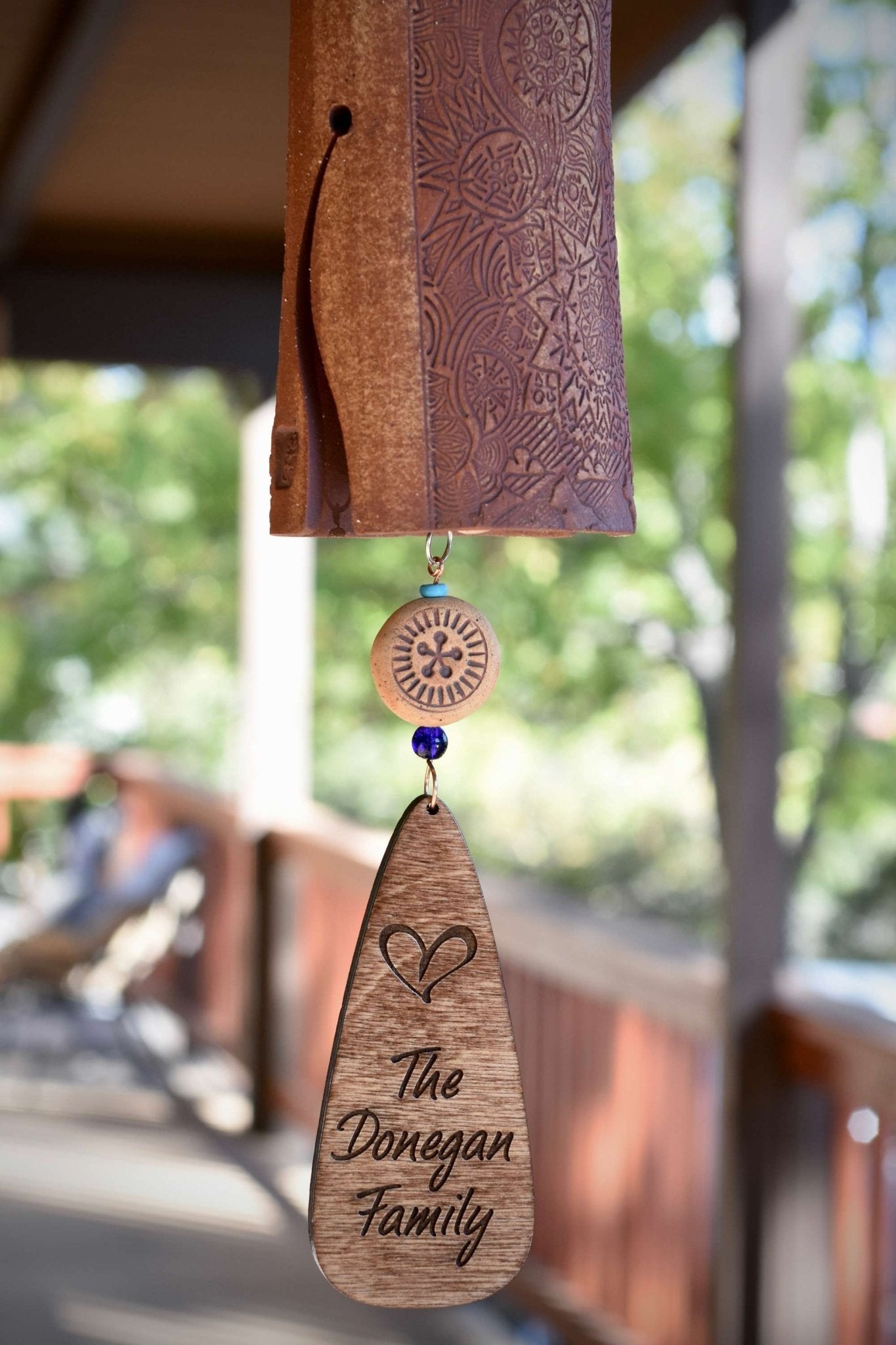 Mixed clay ceramic wind chime with blue glazed bird and engraved wind sail