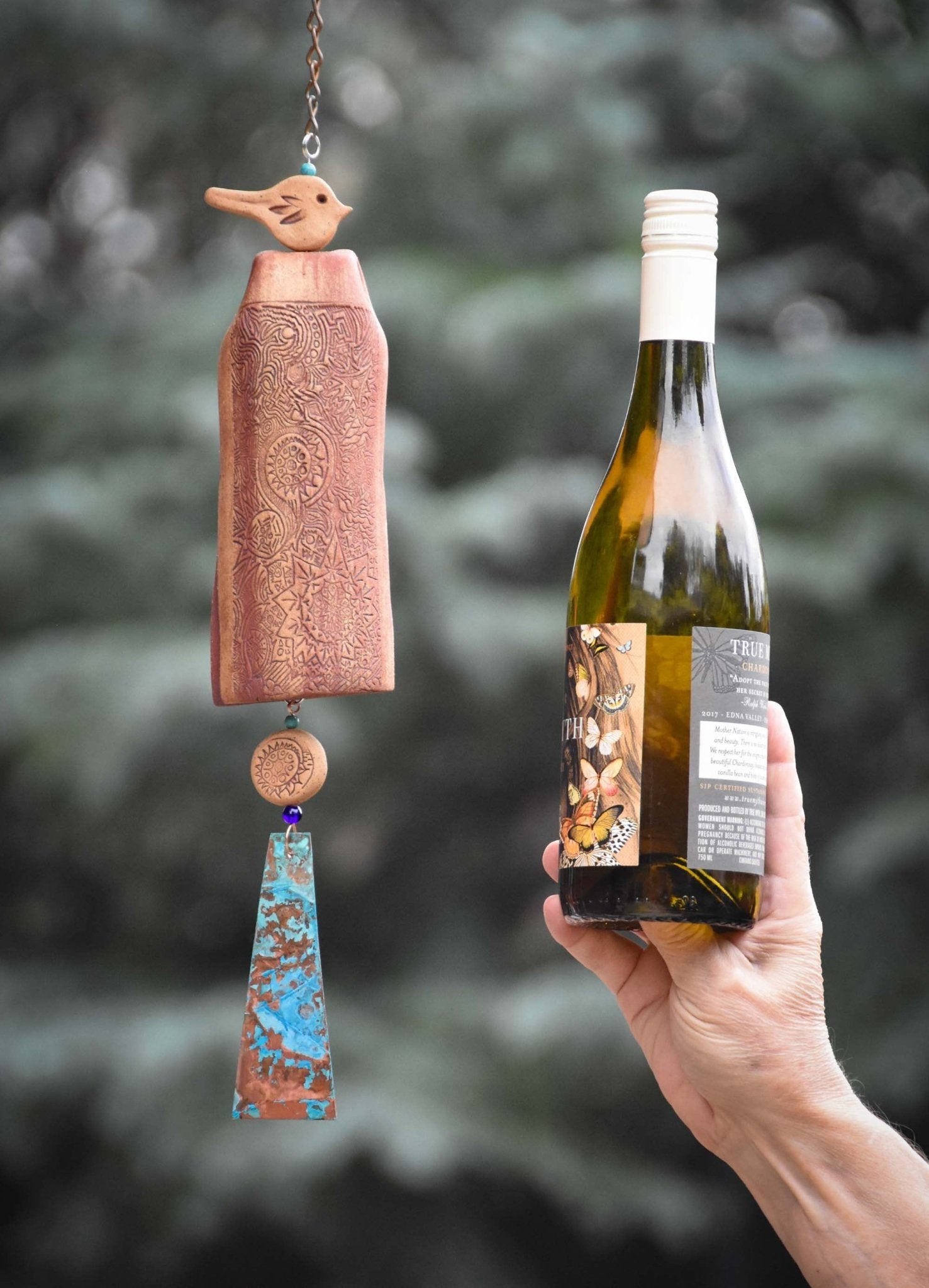 Mixed starburst ceramic wind chime design with rustic tan bird comparing size