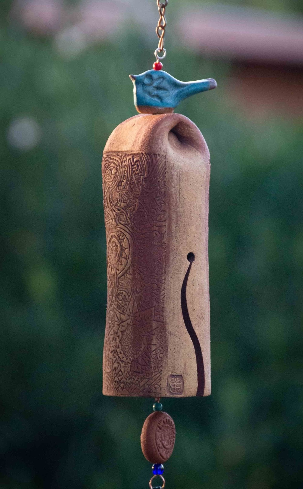 Glazed blue bird wind chime with rustic red bead and white clay bell – outdoor memorial gift with gentle, soothing tones.