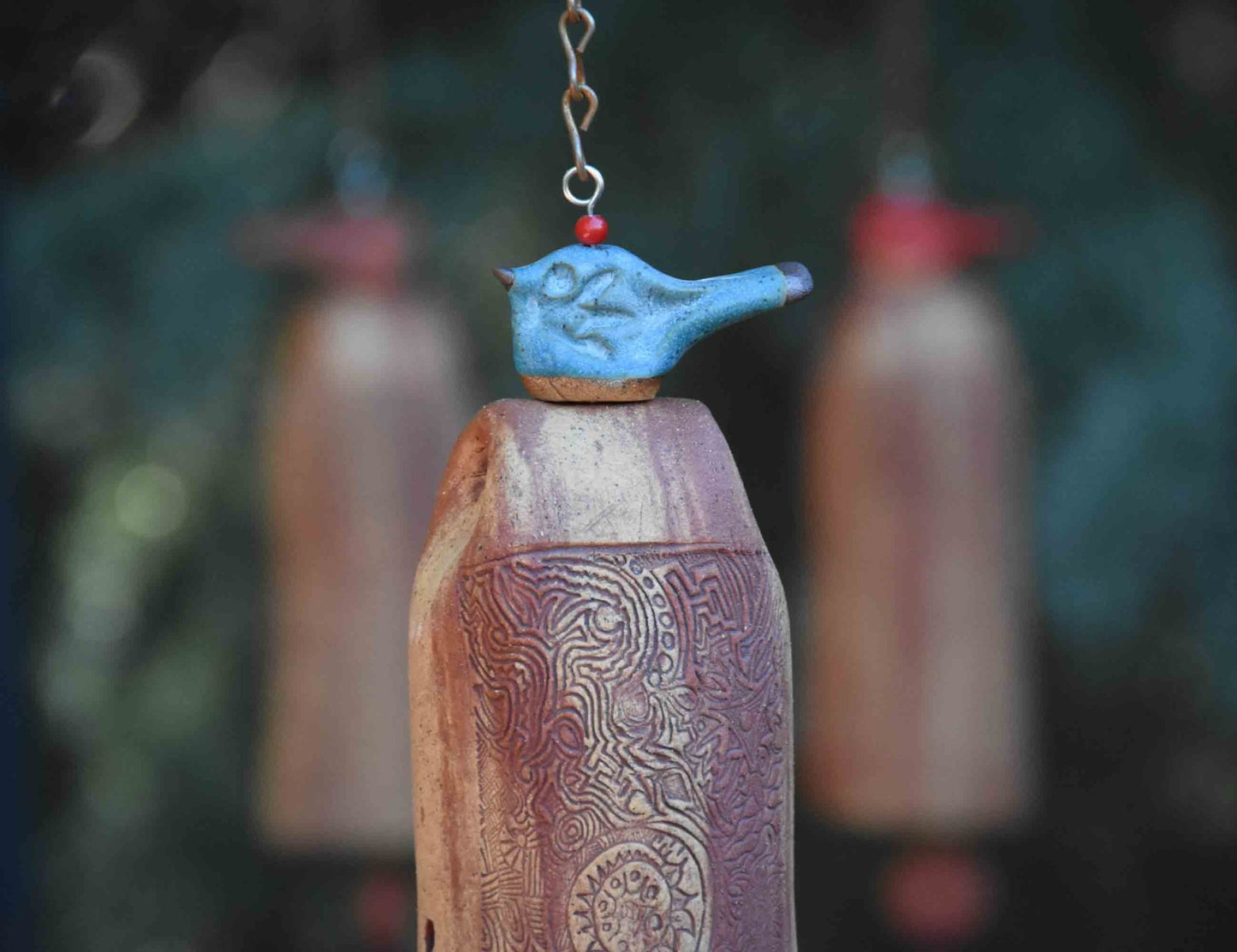 Glazed blue bird wind chime with rustic tan bead and white clay bell – outdoor memorial gift with gentle, soothing tones.