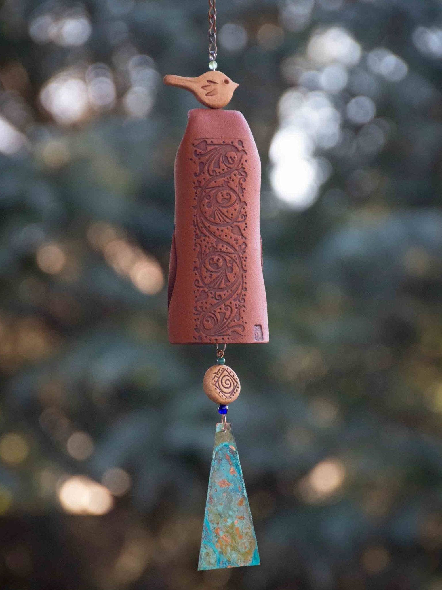 Handcrafted pottery wind chime with wooden clapper and copper sail