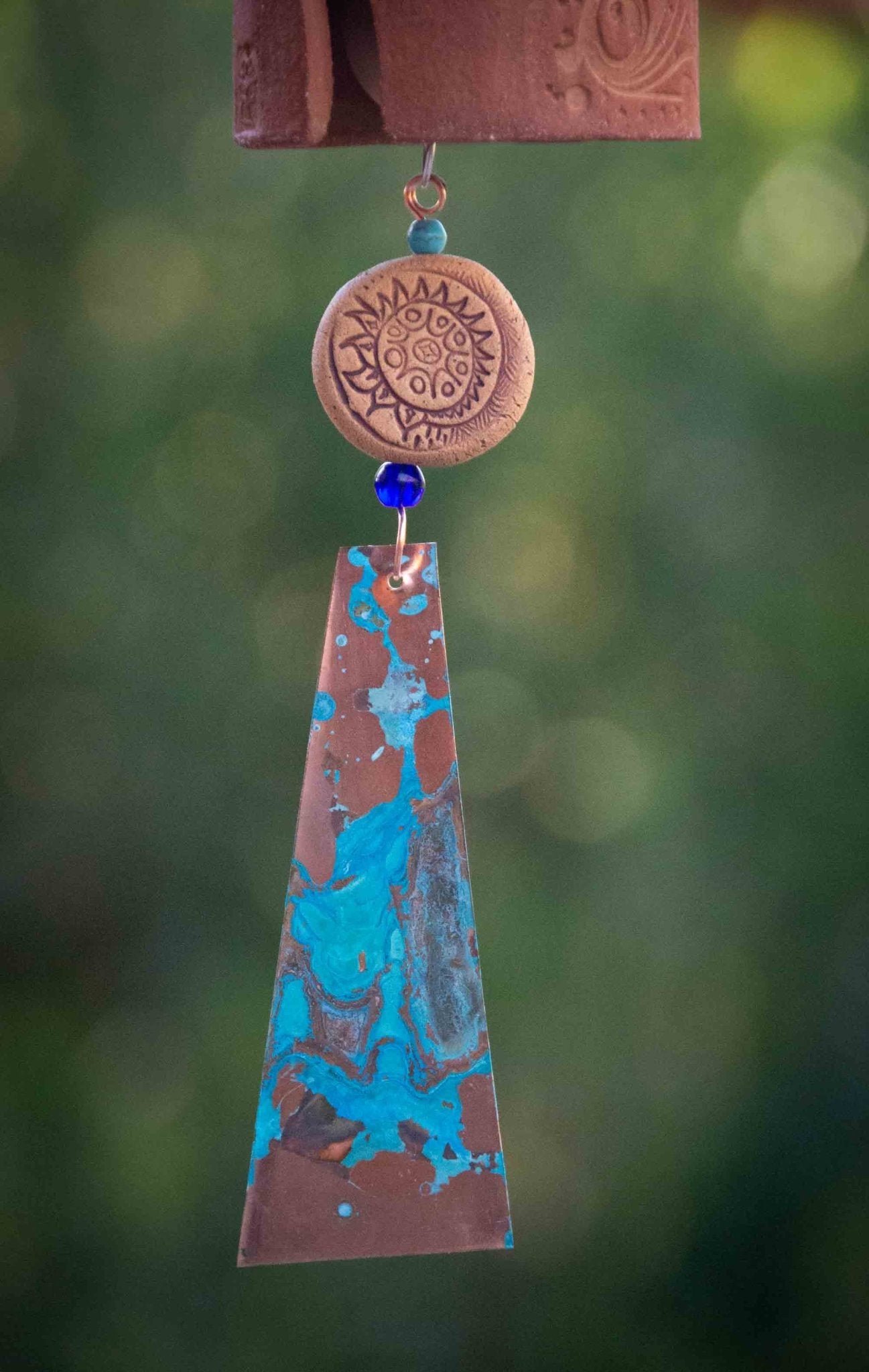 Rustic tan ceramic bead and copper wind sail