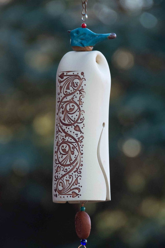 ceramic wind chime with blue glazed bird topper and rustic white bell body